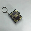 Keychain designed like a miniature Bible on a white background